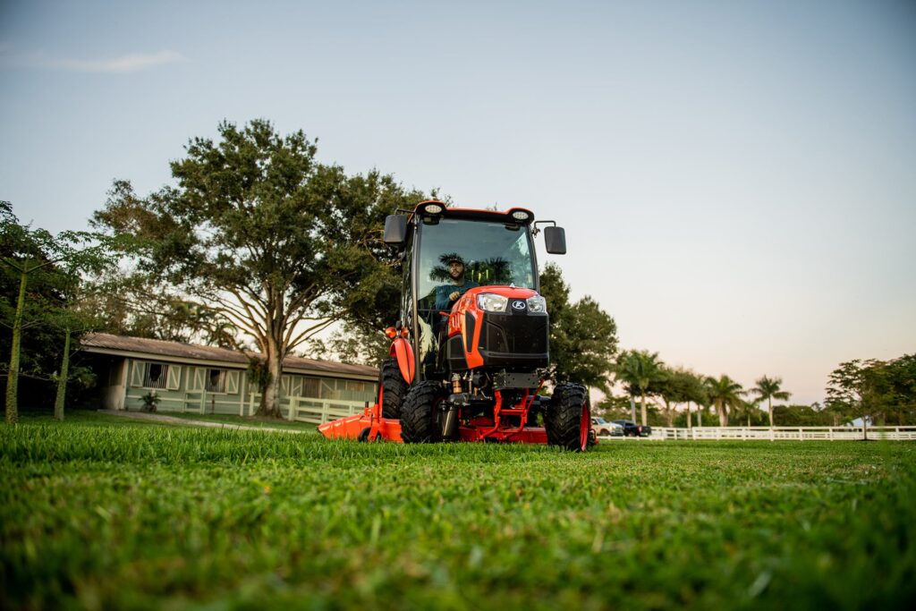 Kubota LX cab tractor mowing