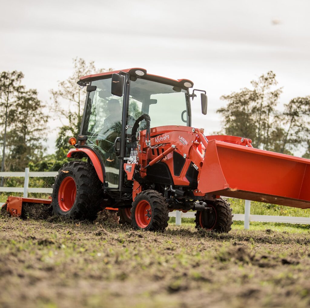 Kubota LX cab tractor operator station while tilling
