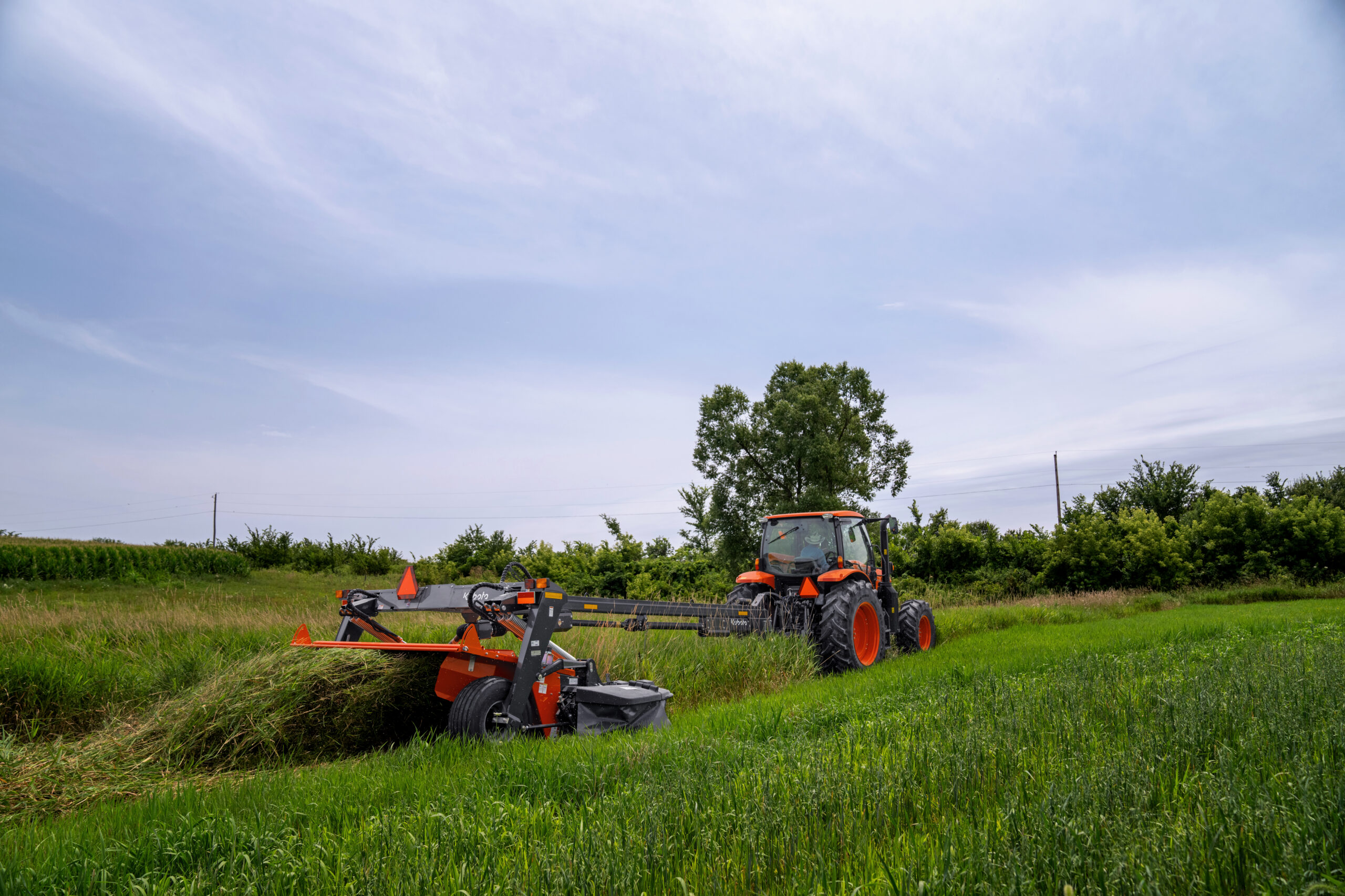 Kubota DMC8536R mower conditioner with M6 tractor in hay field