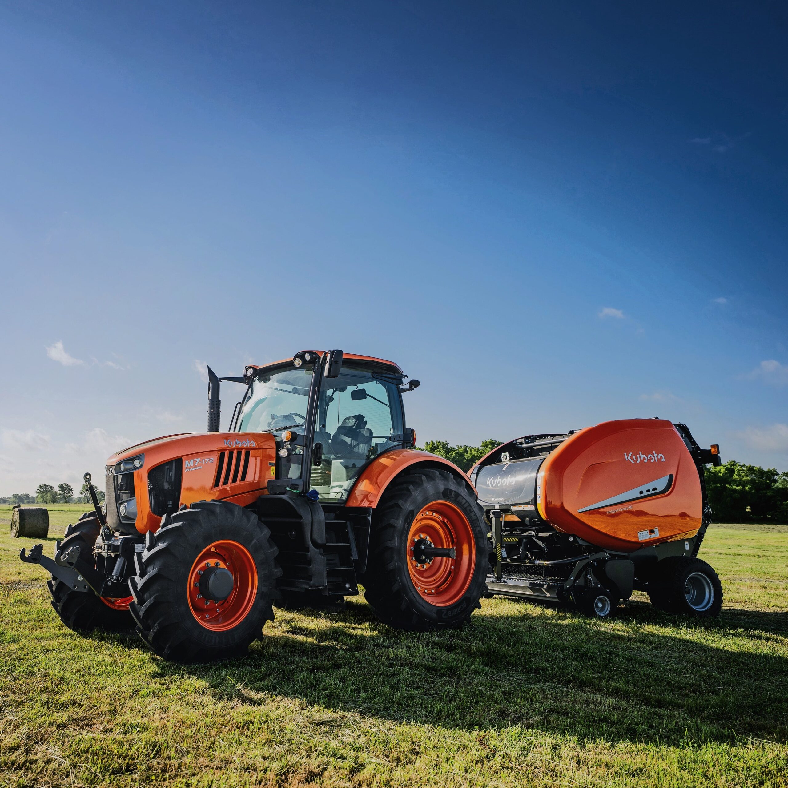 Kubota BV4580 round baler behind Kubota M7 tractor