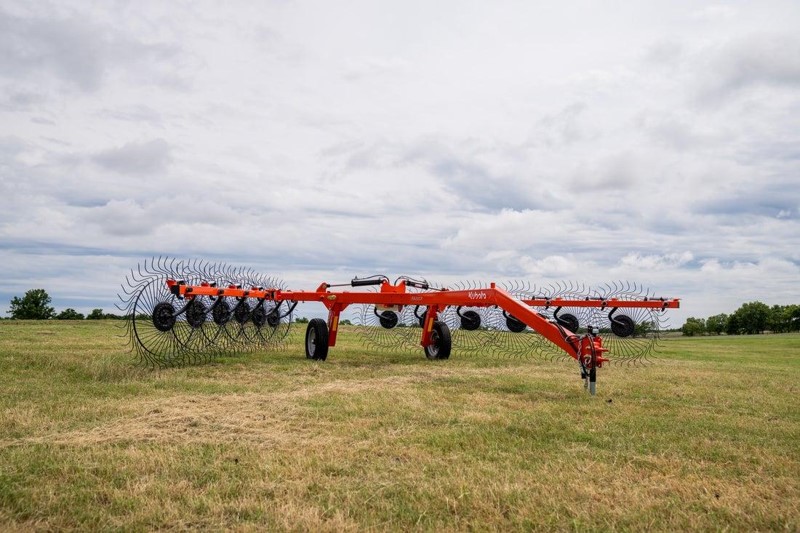 Kubota wheel rake working in a hay field